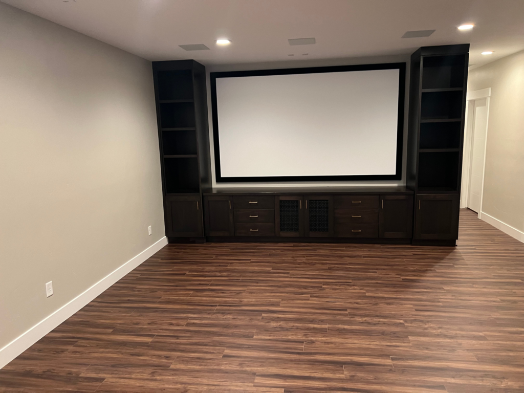 Bright open basement apartment with built-in cabinetry and durable flooring